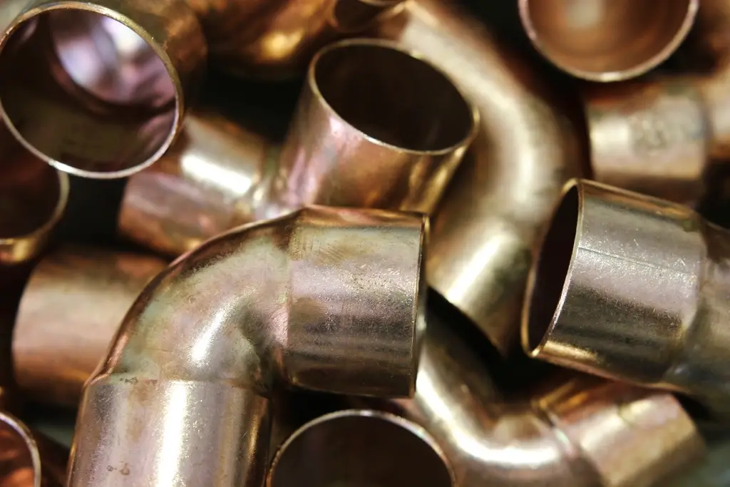 Pile of copper pipe elbow fittings