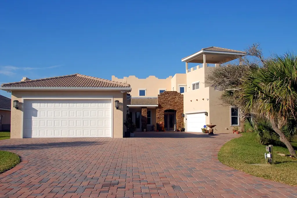 Mediterranean-style home with a paver driveway