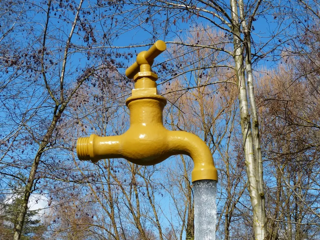 Outdoor water faucet with water running